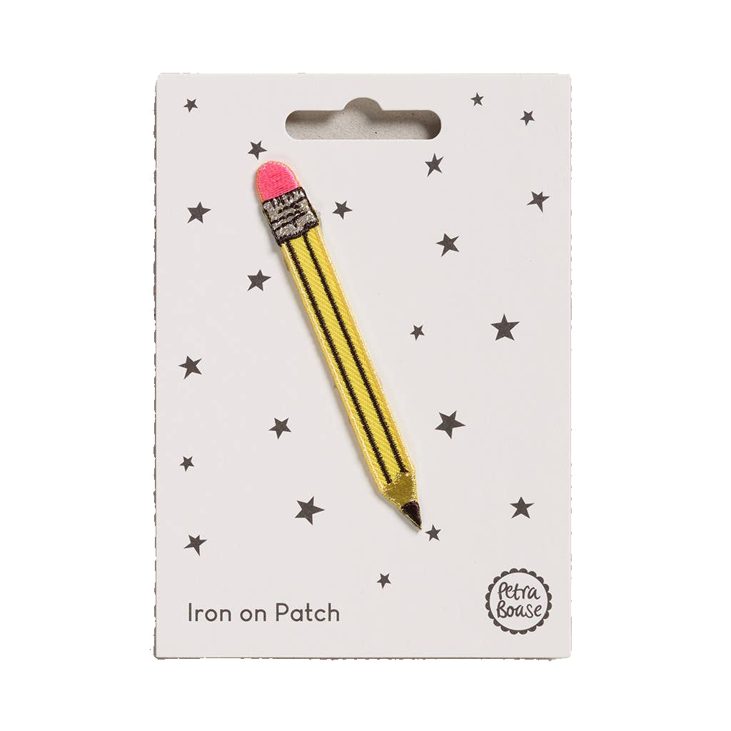 Yellow pencil-shaped iron on patch with a pink eraser on a white card with star patterns.