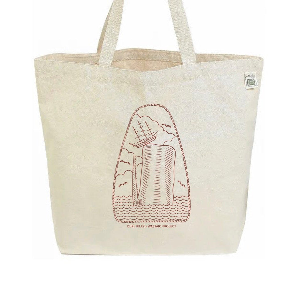 Beige tote bag with a red graphic design of a whale destroying a ship on a white background
